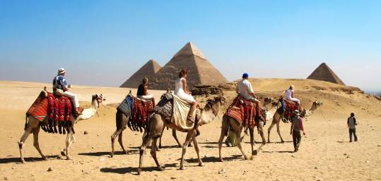 Travellers enjoying a camel ride at Giza Plateau (by Festival Tours)